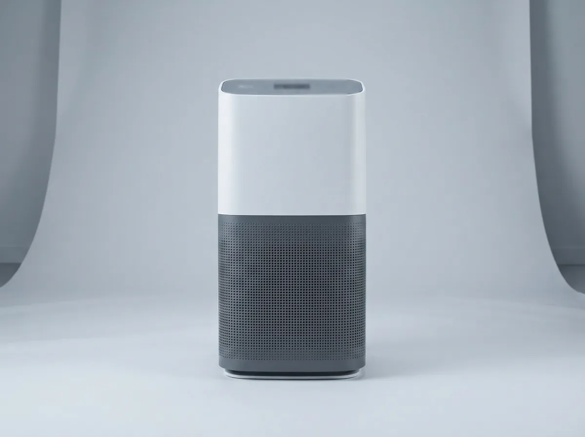 Winix C610 air purifier on a gray studio surface with its 360-degree intake grille visible