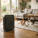 Winix 5500-2 air purifier running in a living room where two cats play on a rug