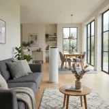 asset_08675ee350c57b7f An unbranded air purifier standing mid-room in a bright open-plan living and dining area
