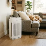 asset_1bd996228aac44fe Winix C535 air purifier on a living room floor near a sofa with a dog resting nearby