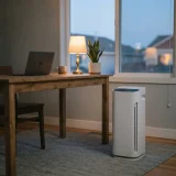 asset_38a16b1c409138ff Winix C545 air purifier running quietly beside a desk in a home office at dusk