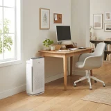 Winix Zero air purifier beside a desk and chair in a tidy home office during the workday