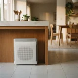 Winix air purifier near an open kitchen counter and dining table