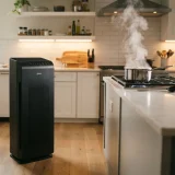 Winix 5510 air purifier positioned at the edge of a kitchen where steam rises from a stovetop pan