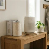 A new Winix Filter Z canister stored on a shelf beside a Winix C610 air purifier in a hallway
