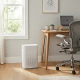 asset_5736a7b5d1fccdc7 Winix T500 air purifier on the floor beside a desk in a home office with a chair