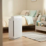 Winix Zero air purifier running in a child's bedroom next to a small bookshelf