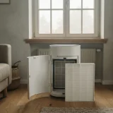 White pleated filter beside an open purifier filter bay near a closed living room window