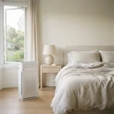 asset_5f837fc67fdcae83 Winix C535 air purifier running beside a bed with open window and morning light in a bedroom