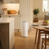 asset_60d479af9b97720b Air purifier placed between a kitchen counter and dining table