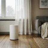 asset_6a4ec67c2a98cd0f Air purifier running near a closed window during hazy outdoor conditions