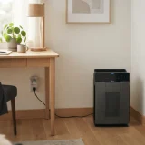 Winix 5500-2 air purifier running on a low fan speed in a sunlit home office corner