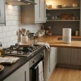 asset_87941de80684831b A kitchen with a pan on the stove and an air purifier standing on the counter end