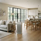 Winix AM90 air purifier standing between a sofa and a dining table in an open-plan main floor