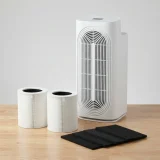 asset_8ba6d2bdacb9bc6b Winix C545 air purifier with spare HEPA cartridges and carbon filter panels arranged beside it