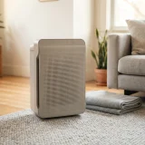 Winix air purifier beside a pet blanket on a living room rug