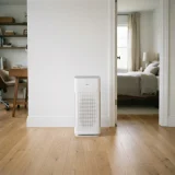 asset_993fd65d97e25981 Winix C545 air purifier standing in an open doorway between two rooms on hardwood flooring