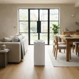 Winix Zero air purifier between a sofa and a dining table in an open-plan living space