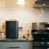 A Winix A230 air purifier on a kitchen counter beside a cooling pan with faint steam in the air