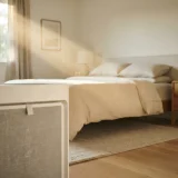 asset_ae924a19f896222a Fine dust motes drifting through a sunlit bedroom beam with a filter panel in soft focus