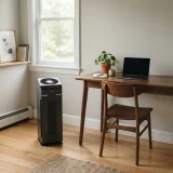 A Winix 5300-2 air purifier running beside a desk in a bright home office