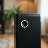 Close-up of the Winix 5510 air quality sensor and indicator light glowing on the front of the black tower unit