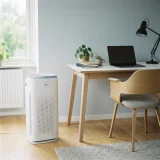 asset_c933f32952b69b6f Winix C610 air purifier on the floor beside an office desk and chair in a home studio corner