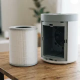 Filter cartridge and open filter compartment on an air purifier being prepared for a change