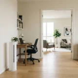 Two Winix AM90 air purifiers running in separate rooms of a shared apartment