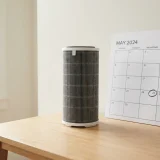 asset_ee64cee8185526fe Winix Filter Z canister standing beside a plain wall calendar marking the annual filter change