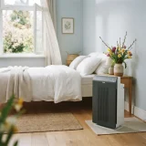 asset_fcca2f47a2ac9ab7 Winix T810 running beside a bed in a bright bedroom with an open window.